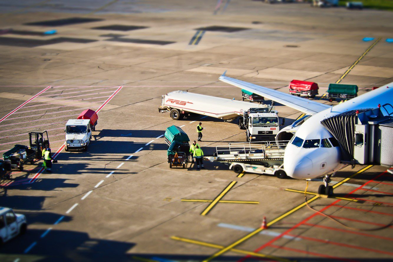 White aeroplane on ramp of airport being loaded and fueled- SkyLearner aviation