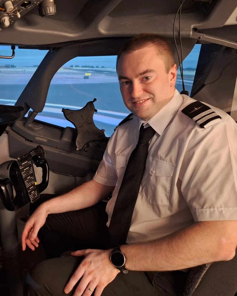 Alan Martin in an airline flight simulator cockpit