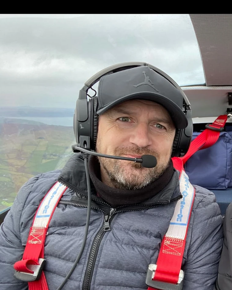 Daniel Brennan flying with a headset and harness