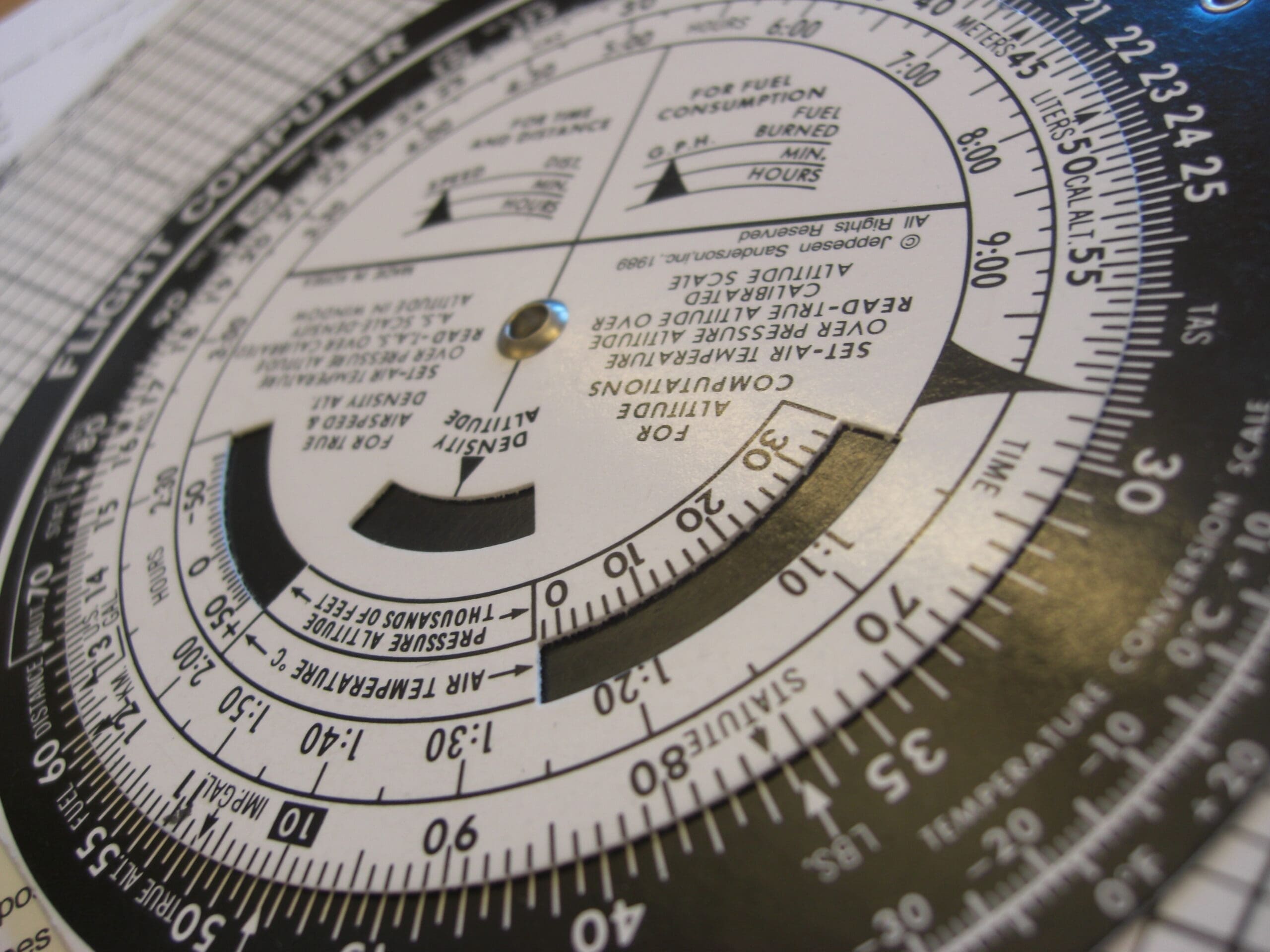 Close-up of an E6B flight computer used for navigation calculations